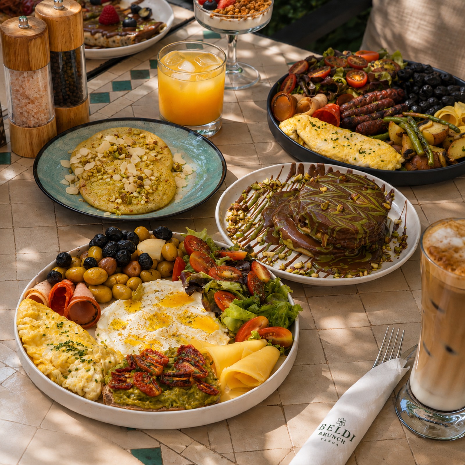 Plateau brunch complet vu de dessus : œufs, avocat, fruits, jus